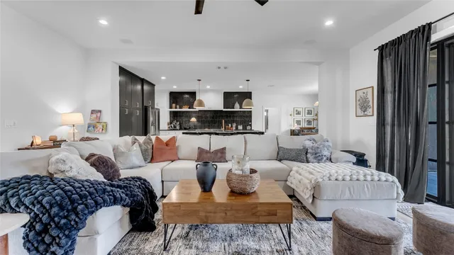 a living room with furniture a lamp and a flat screen tv