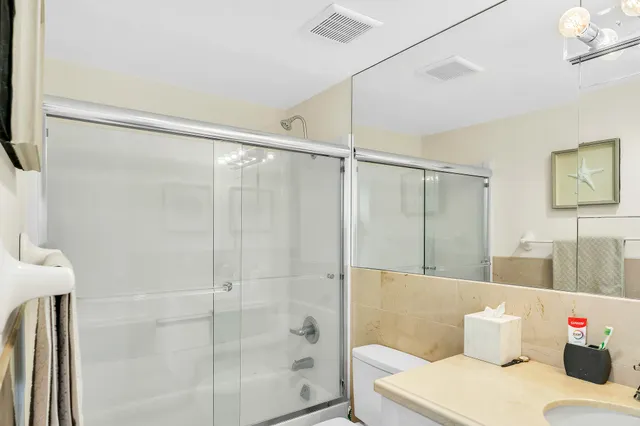 a view of a bathroom with a shower tub and sink