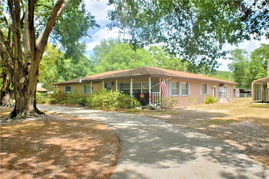 6731 Ranch Road Lakeland, FL 33809 - Photo 1 of 1 Beautiful shady oaks and a large circular drive with ample parking and a covered carport too
