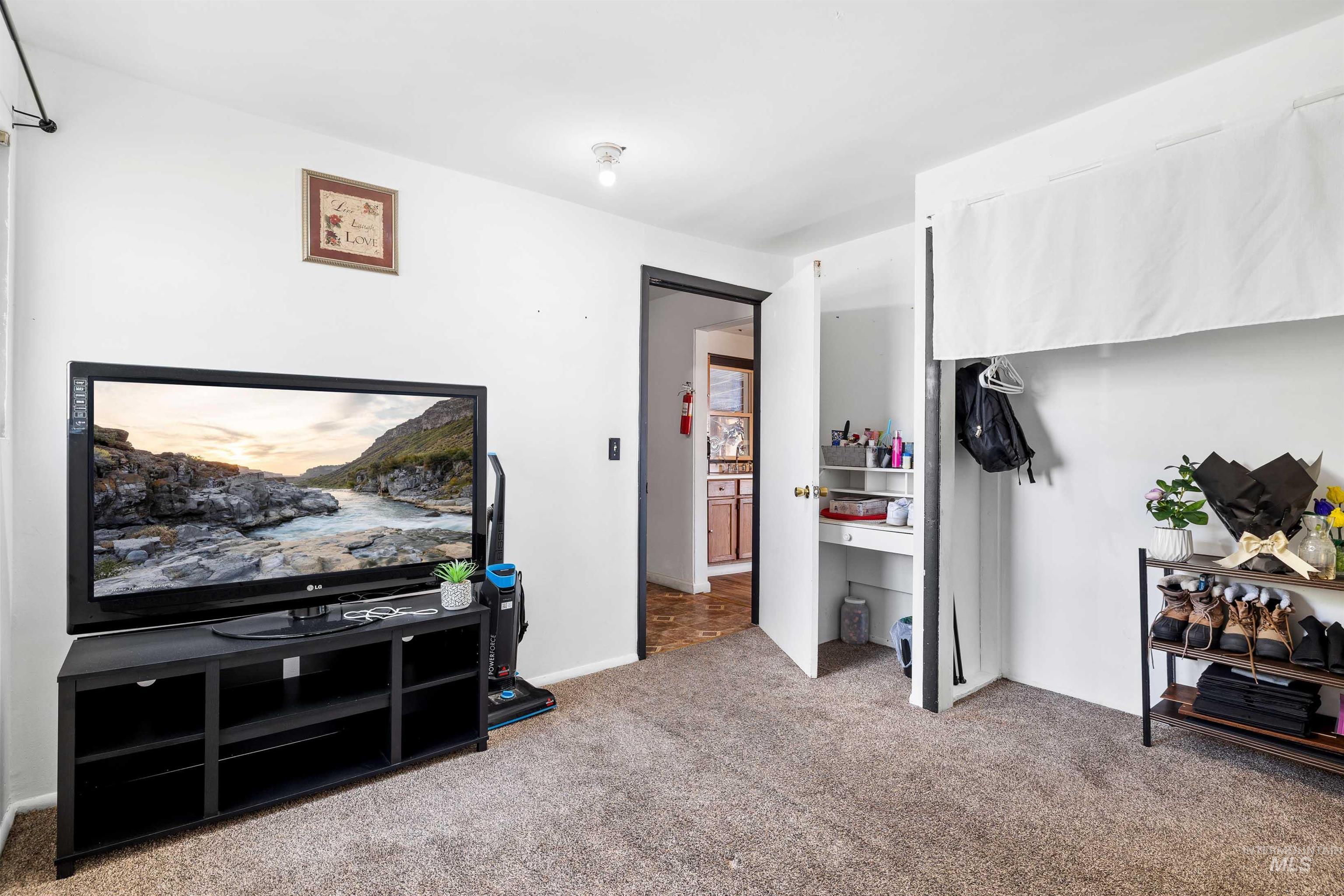 102 East 6th Street Rupert, ID 83350 - Photo 13 of 27 Carpeted room featuring white walls and a built-in closet with shelving