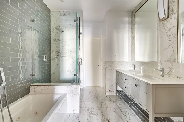 a bathroom with a tub sink and mirror