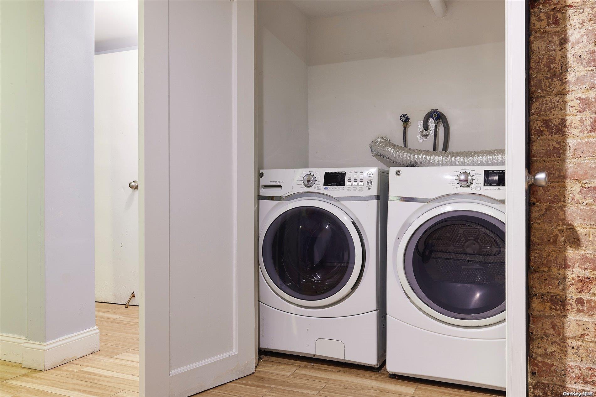 266 West 136th Street Manhattan, NY 10030 - Photo 19 of 22 a utility room with dryer and washer