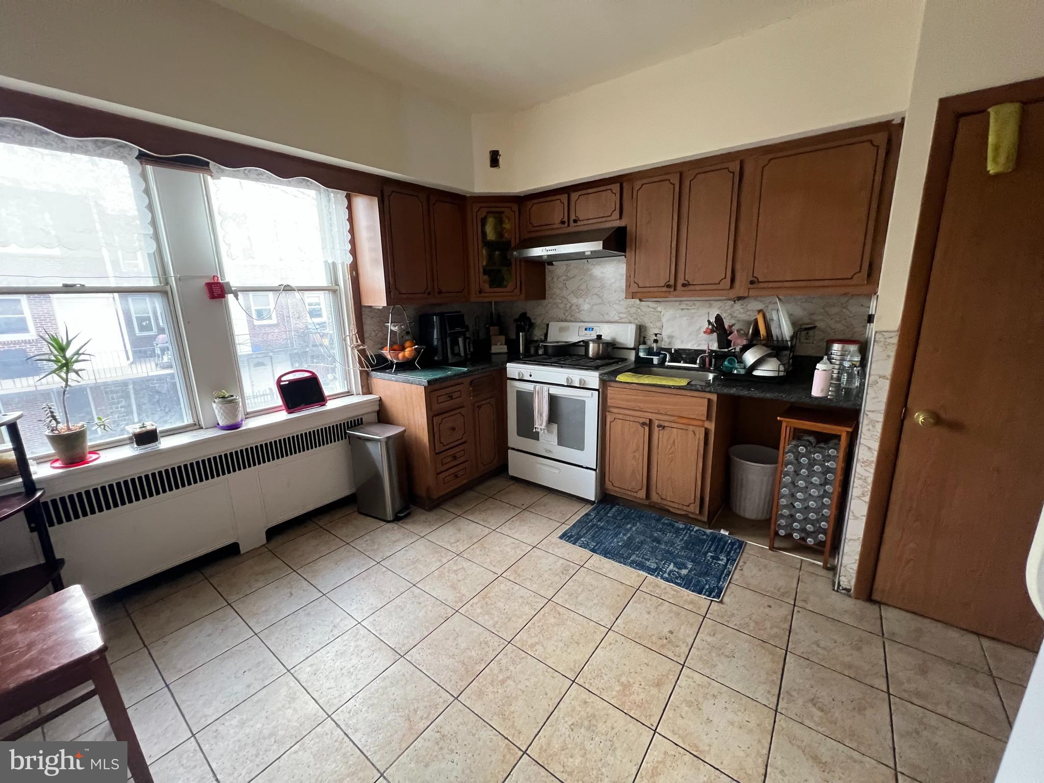 3158 Fanshawe Street Philadelphia, PA 19149 - Photo 2 of 8 a kitchen with stainless steel appliances granite countertop a stove a sink and a refrigerator