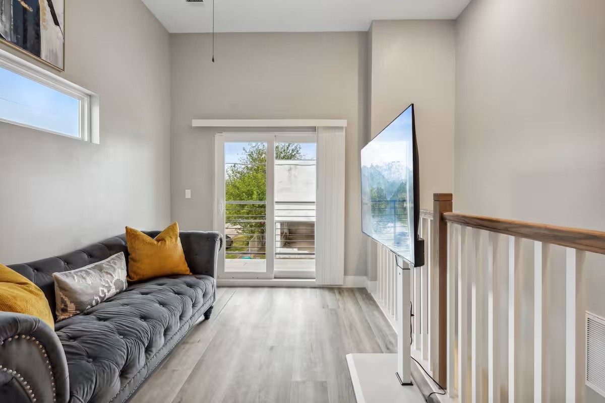 a bedroom with a bed and a large window
