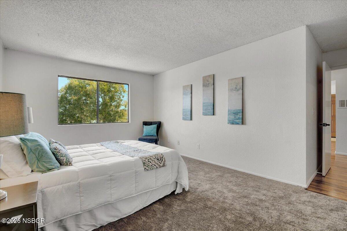 3400 Santa Maria Way, Unit 207B Santa Maria, CA 93455 - Photo 29 of 50 a bedroom with a bed and a couch