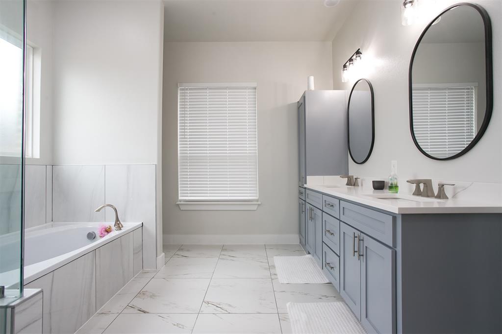 1006 Johnson Trail Bells, TX 75414 - Photo 11 of 19 a bathroom with a sink double vanity and a mirror
