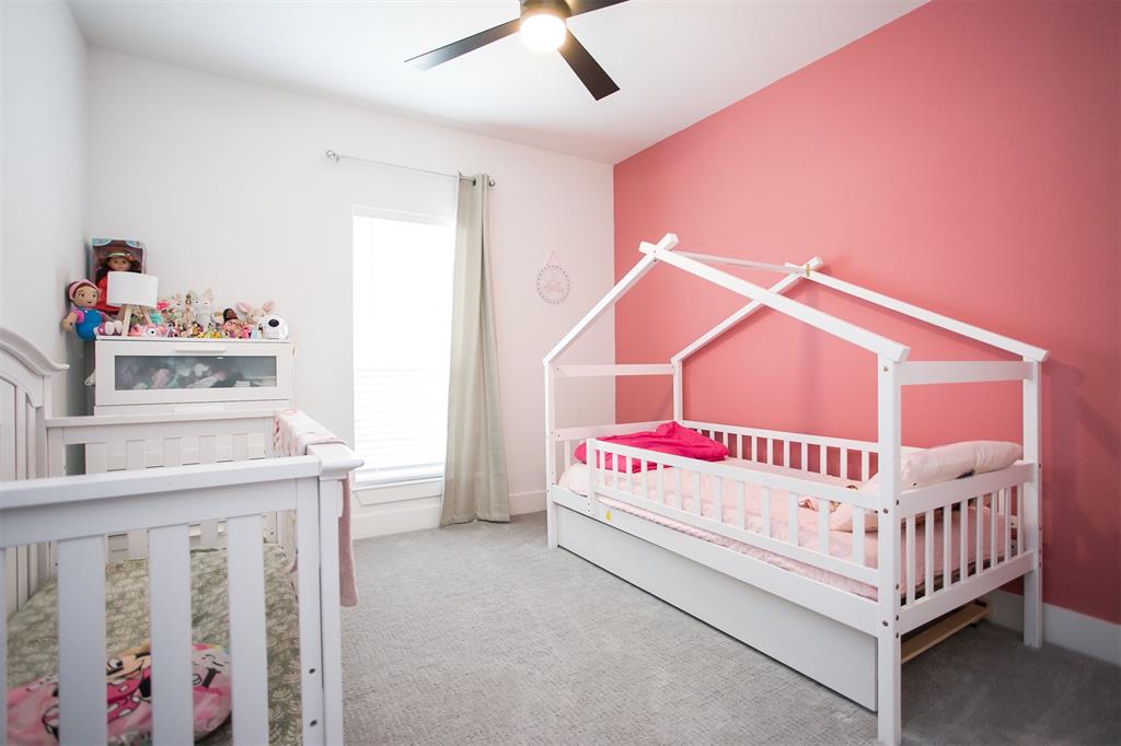 1006 Johnson Trail Bells, TX 75414 - Photo 15 of 19 a white bed sitting in a bedroom next to a window