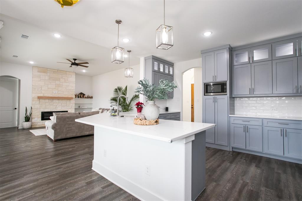 1006 Johnson Trail Bells, TX 75414 - Photo 6 of 19 a kitchen with kitchen island a sink stove and refrigerator