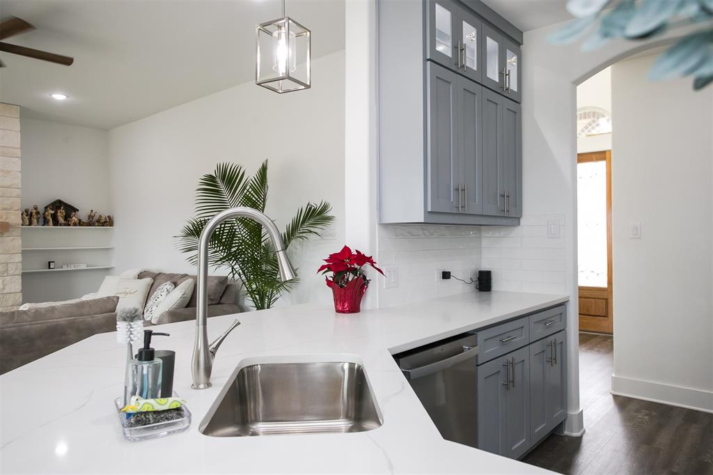 1006 Johnson Trail Bells, TX 75414 - Photo 7 of 19 a kitchen with stainless steel appliances white cabinets and wooden floor