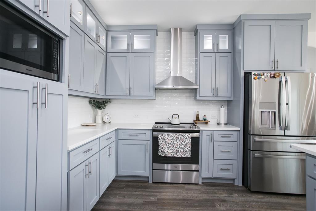 1006 Johnson Trail Bells, TX 75414 - Photo 8 of 19 a kitchen with a refrigerator stove and white cabinets