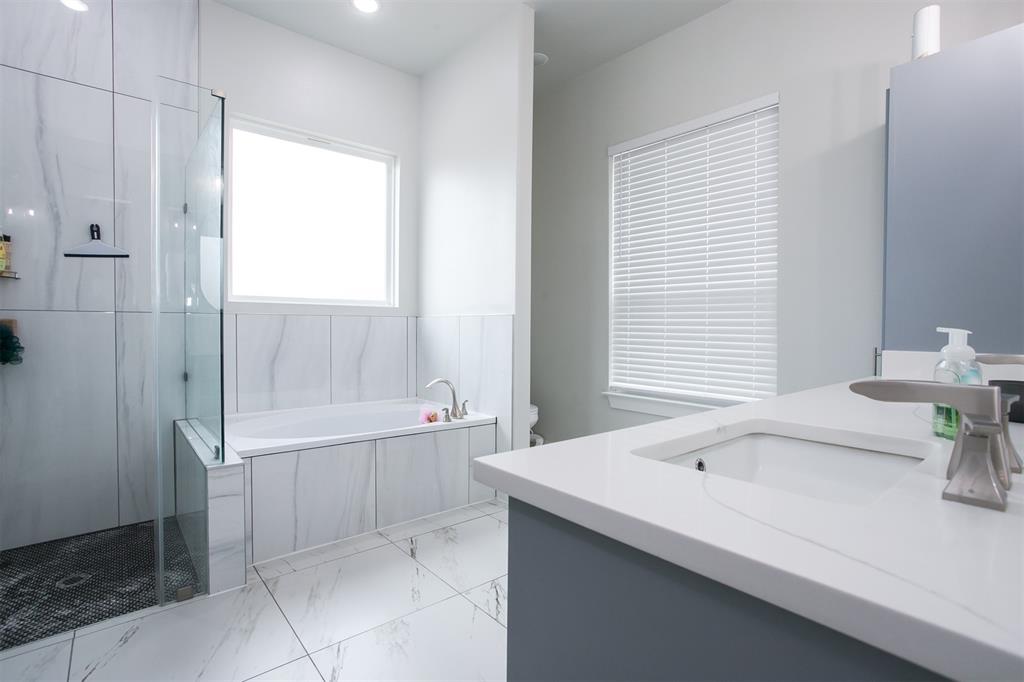 1006 Johnson Trail Bells, TX 75414 - Photo 10 of 19 a bathroom with a bathtub and sink