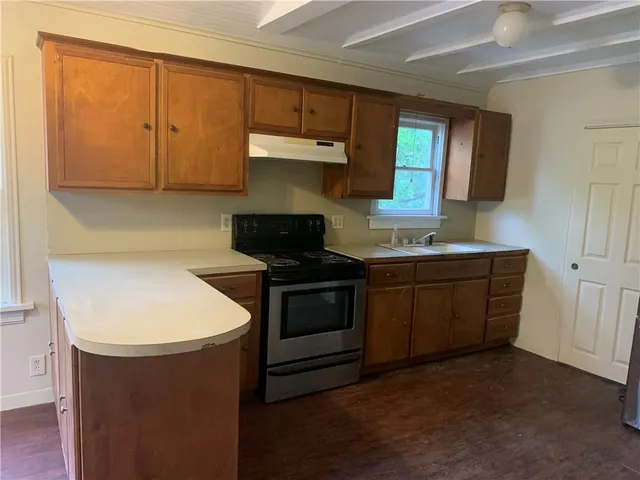 a kitchen with a sink and a stove top oven