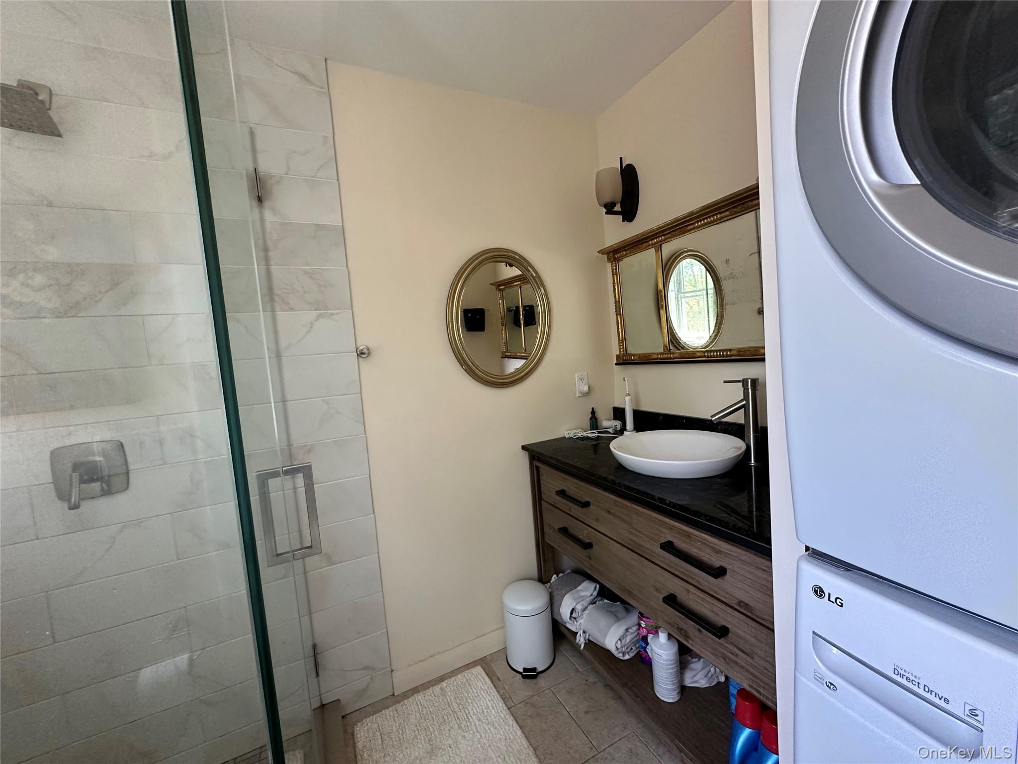1854 North Bayview Road Southold, NY 11971 - Photo 8 of 20 Bathroom featuring a stall shower, vanity, and tile patterned floors