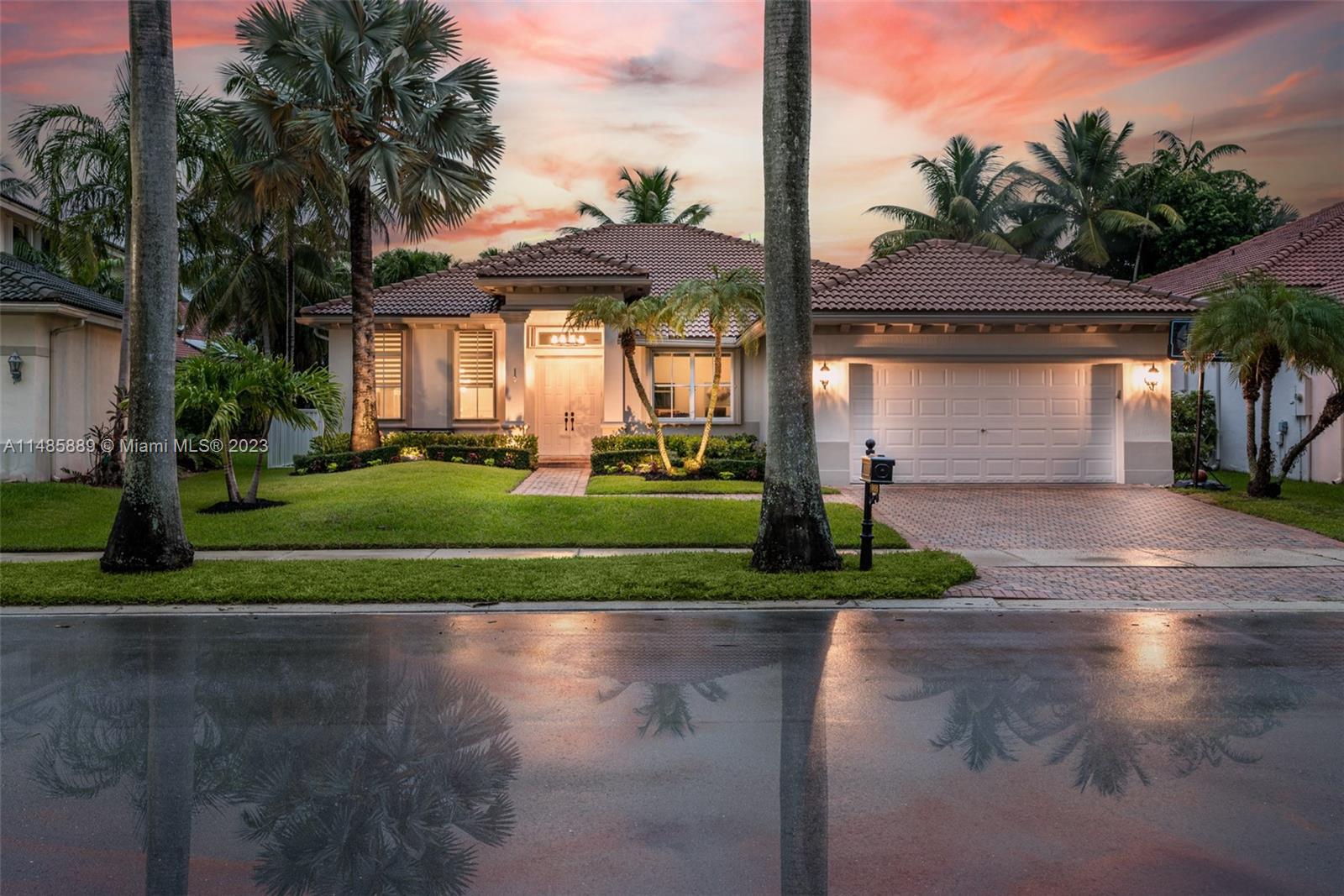 1955 Timberline Road Weston, FL 33327 - Photo 1 of 48 a front view of a house with a yard and potted plants