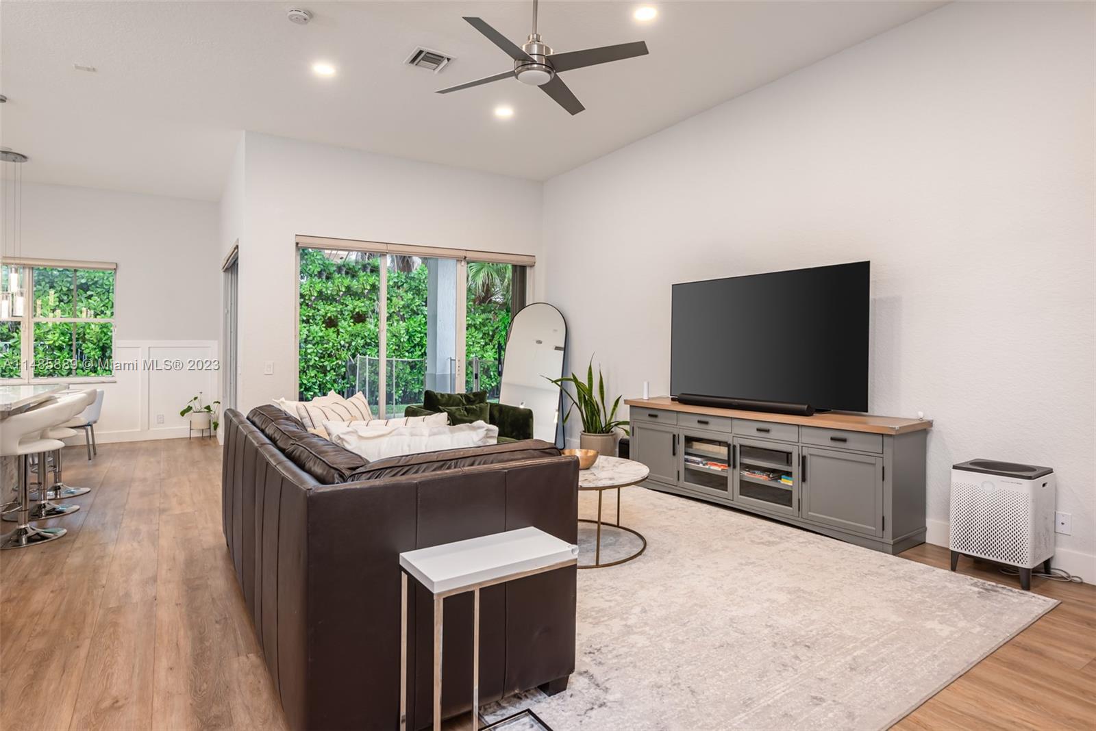 1955 Timberline Road Weston, FL 33327 - Photo 11 of 48 a living room with furniture and a flat screen tv