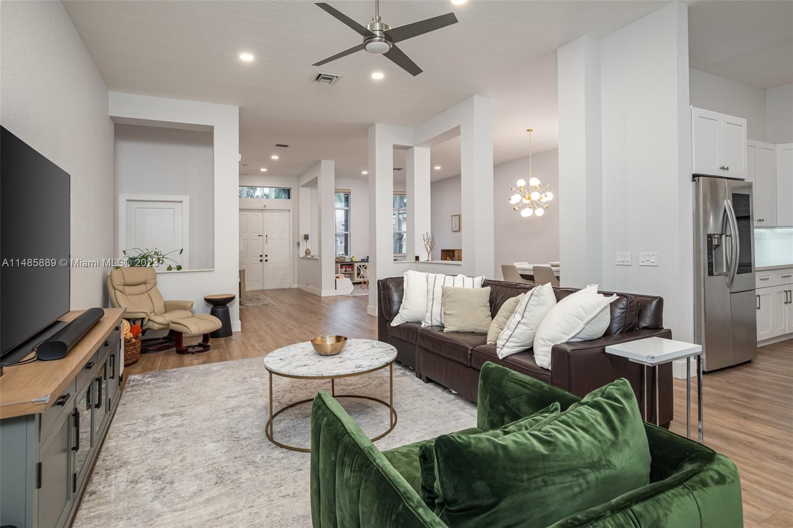 1955 Timberline Road Weston, FL 33327 - Photo 12 of 48 a living room with furniture a rug and a flat screen tv