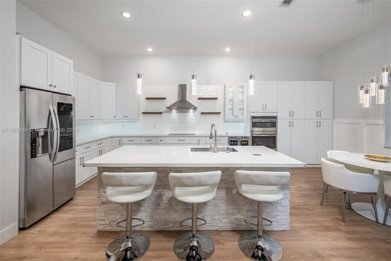 1955 Timberline Road Weston, FL 33327 - Photo 13 of 48 a large kitchen with a table and chairs