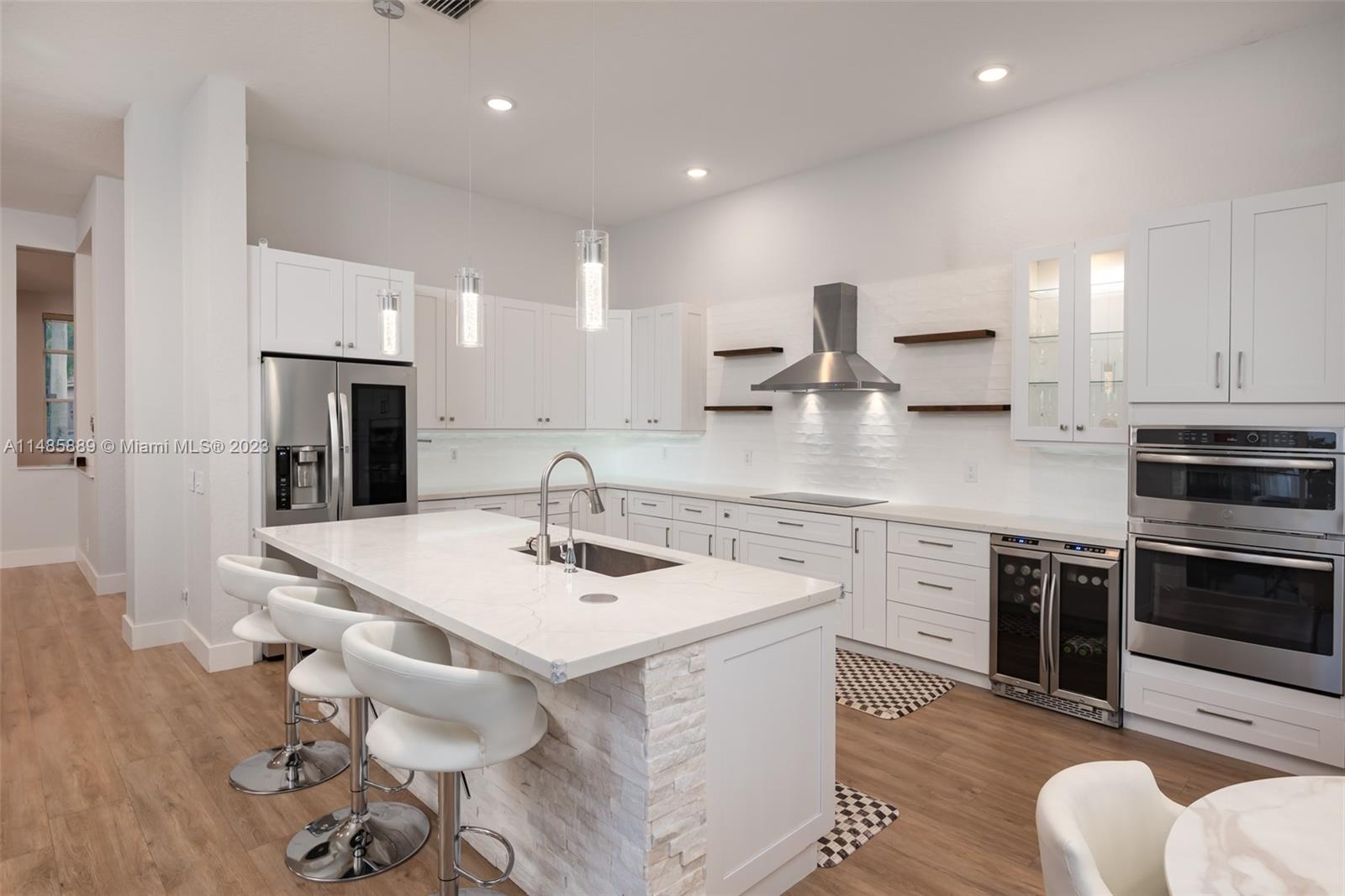 1955 Timberline Road Weston, FL 33327 - Photo 14 of 48 a kitchen with stainless steel appliances kitchen island granite countertop a sink stove and cabinets