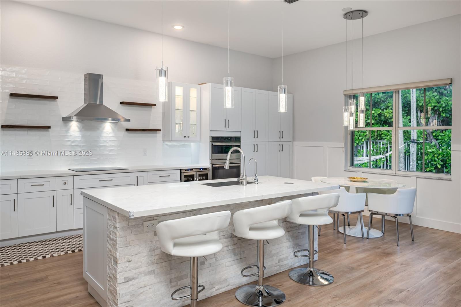 1955 Timberline Road Weston, FL 33327 - Photo 15 of 48 a large kitchen with a table and chairs in it