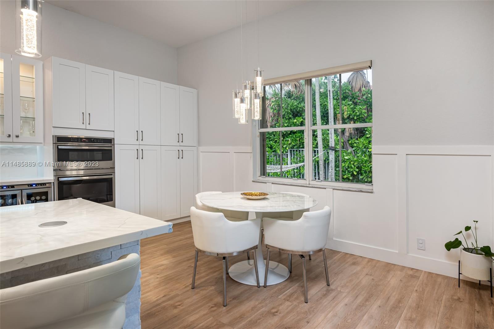 1955 Timberline Road Weston, FL 33327 - Photo 16 of 48 a kitchen with a table chairs stove and refrigerator
