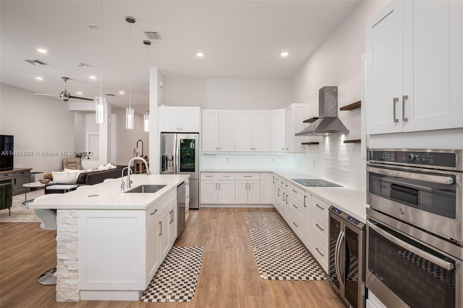 1955 Timberline Road Weston, FL 33327 - Photo 17 of 48 a kitchen with stainless steel appliances kitchen island granite countertop a sink and cabinets