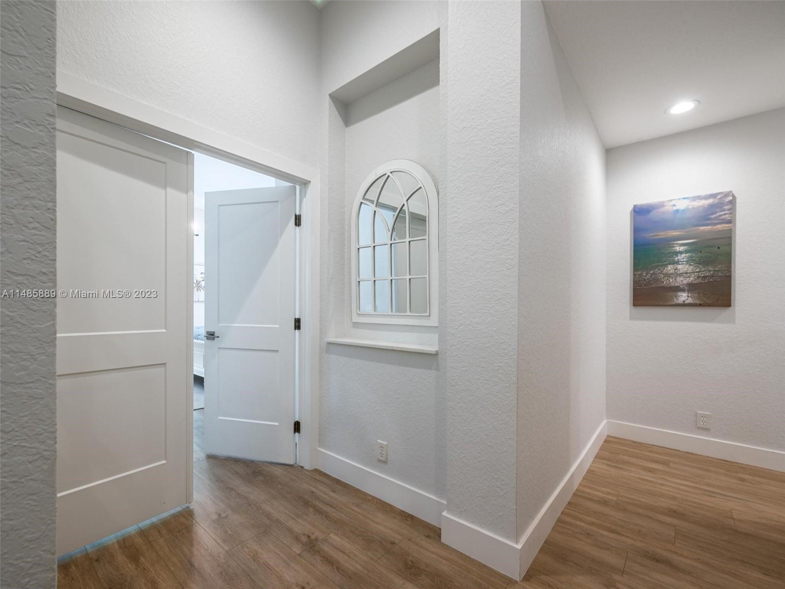 1955 Timberline Road Weston, FL 33327 - Photo 20 of 48 wooden floor in an empty room with a window