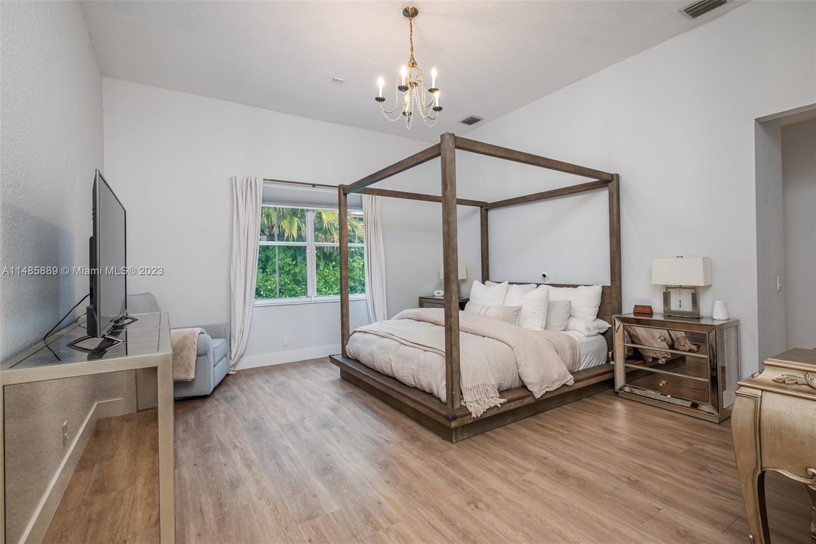 1955 Timberline Road Weston, FL 33327 - Photo 22 of 48 a bedroom with a bed window and a flat screen tv