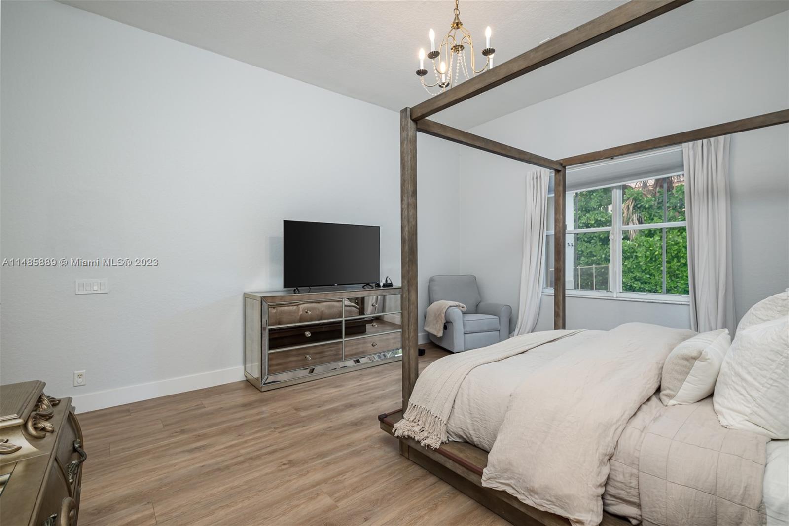 1955 Timberline Road Weston, FL 33327 - Photo 23 of 48 a bedroom with a bed and a flat screen tv