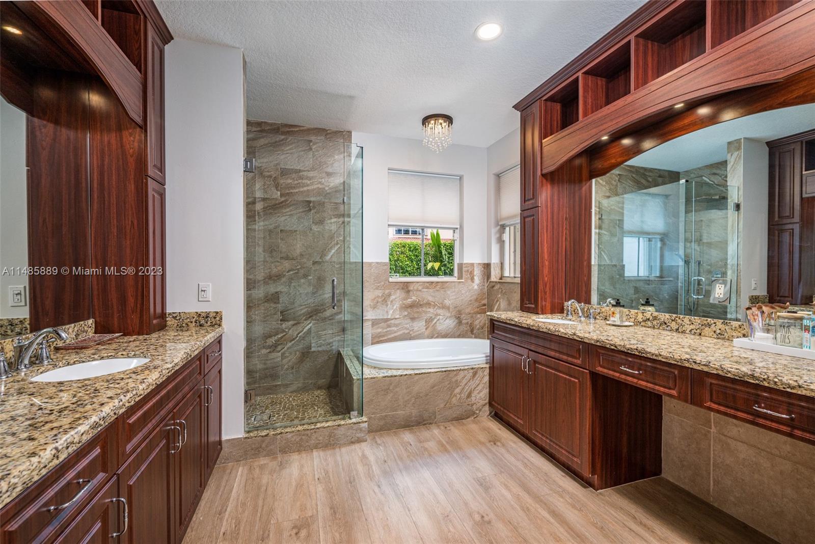 1955 Timberline Road Weston, FL 33327 - Photo 24 of 48 a bathroom with a granite countertop tub sink and mirror
