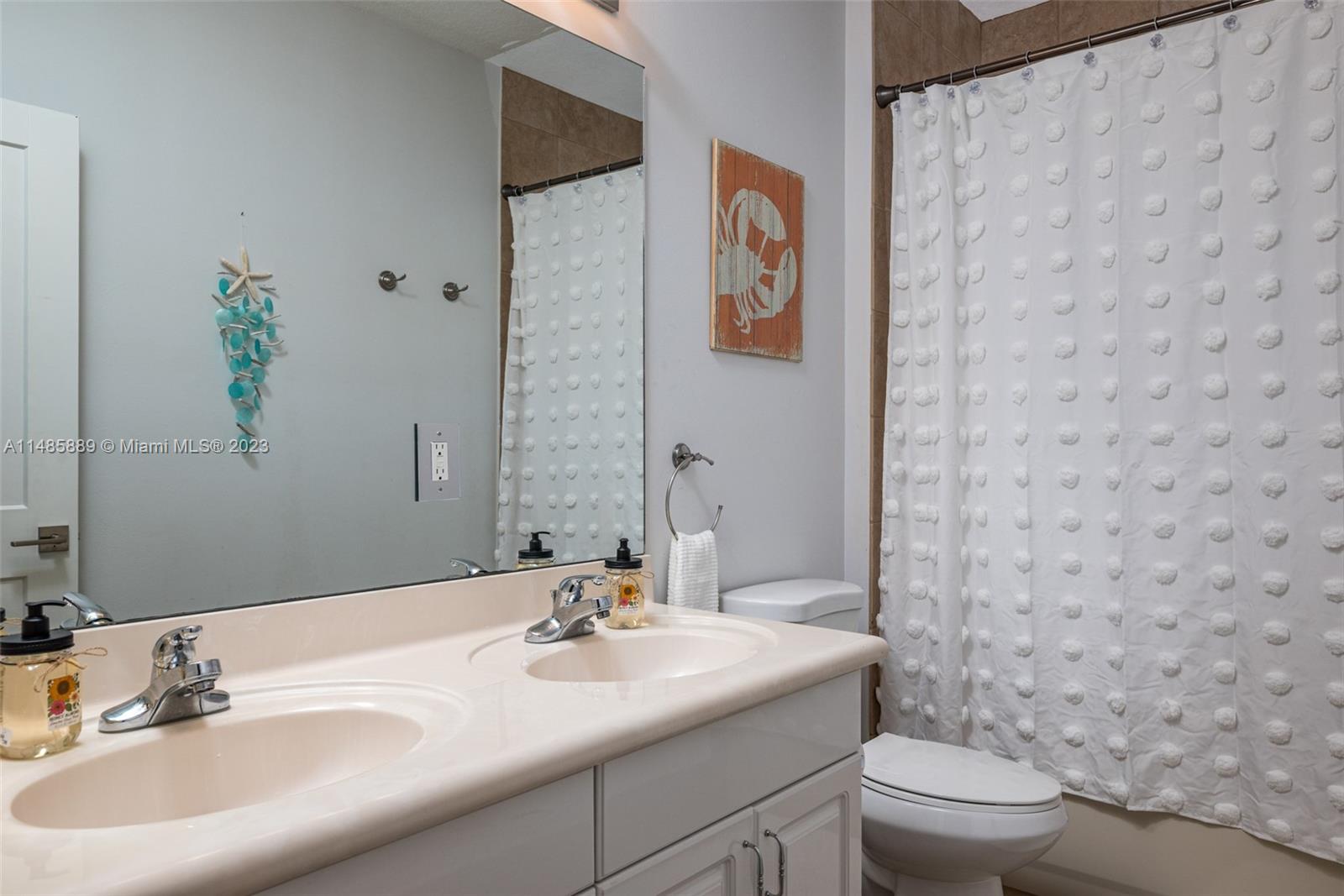 1955 Timberline Road Weston, FL 33327 - Photo 29 of 48 a bathroom with a toilet sink and mirror