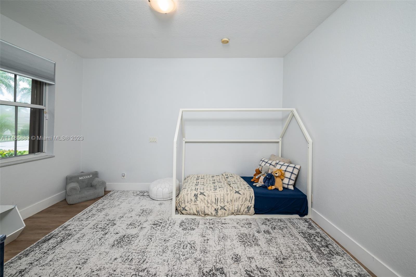 1955 Timberline Road Weston, FL 33327 - Photo 31 of 48 a bedroom with a bed and a window