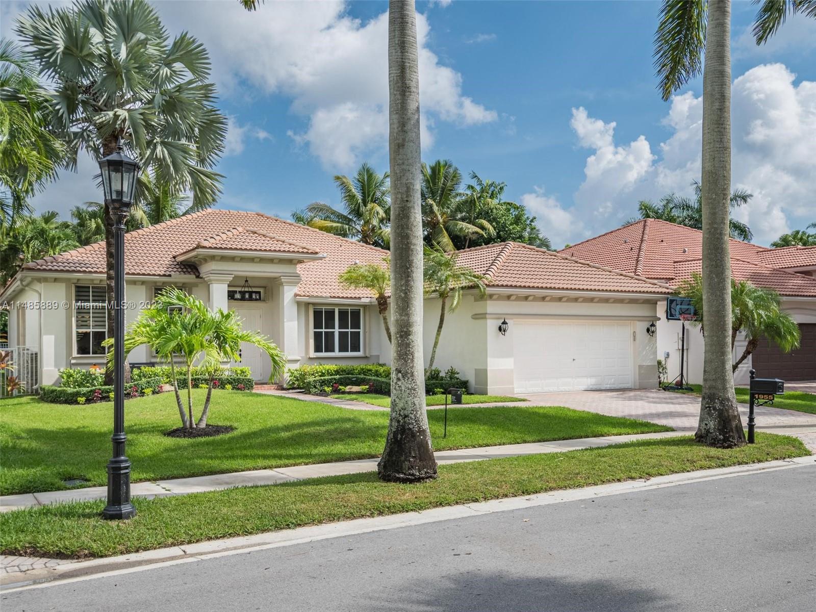 1955 Timberline Road Weston, FL 33327 - Photo 44 of 48 a front view of a house with a yard