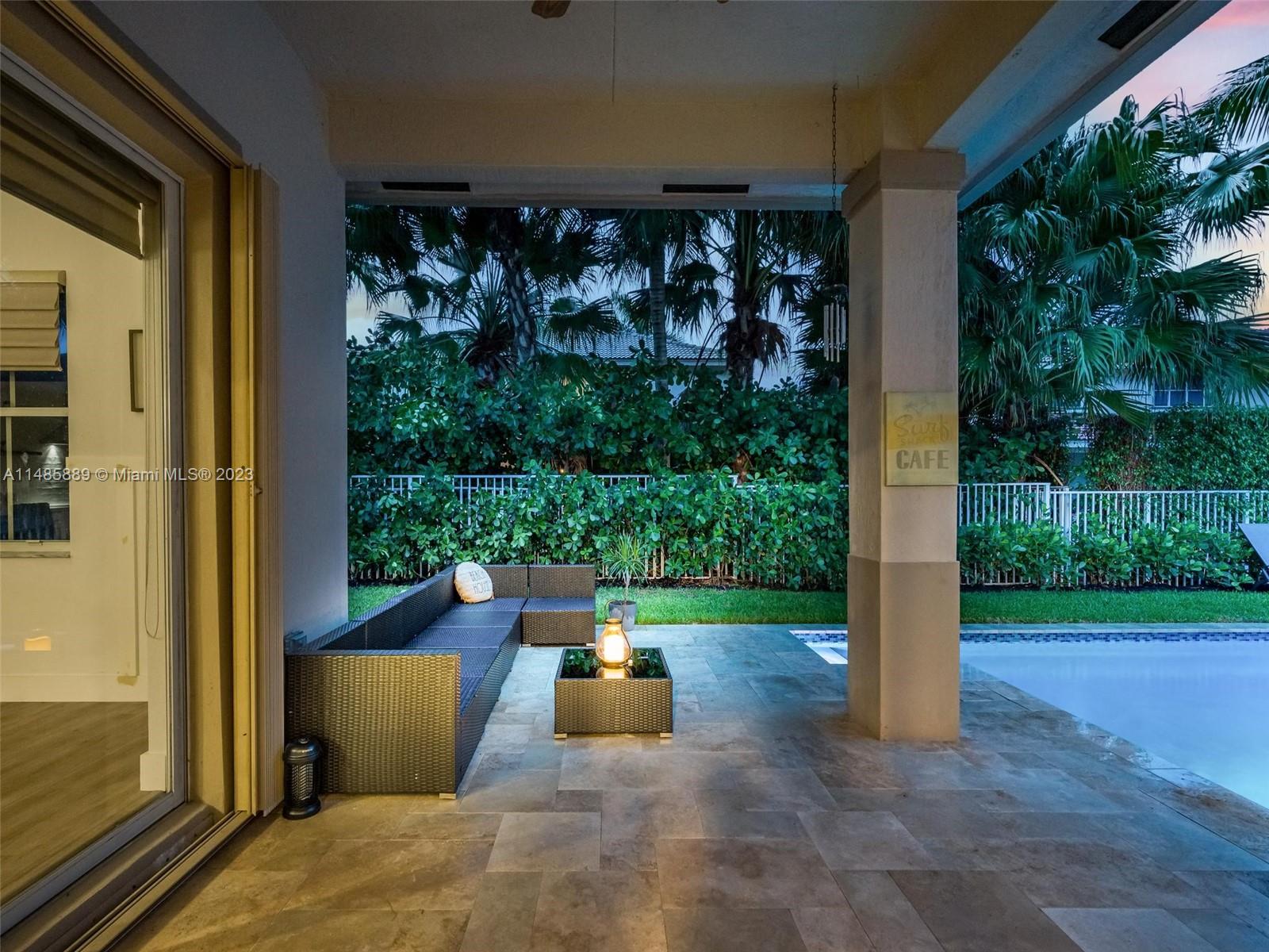 1955 Timberline Road Weston, FL 33327 - Photo 47 of 48 a view of a patio with table and chairs potted plants