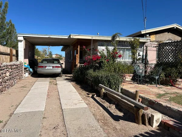 a front view of a house with a street