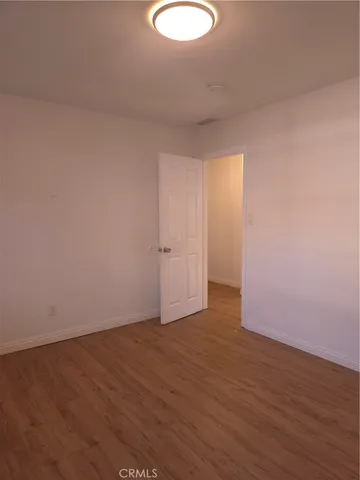 a view of a room with wooden floor