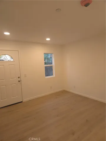 an empty room with a empty space and windows