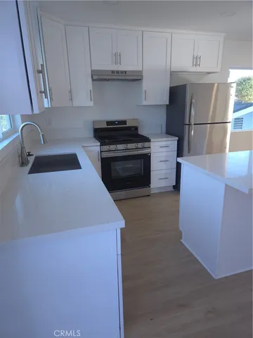 a kitchen with a cabinets and appliances