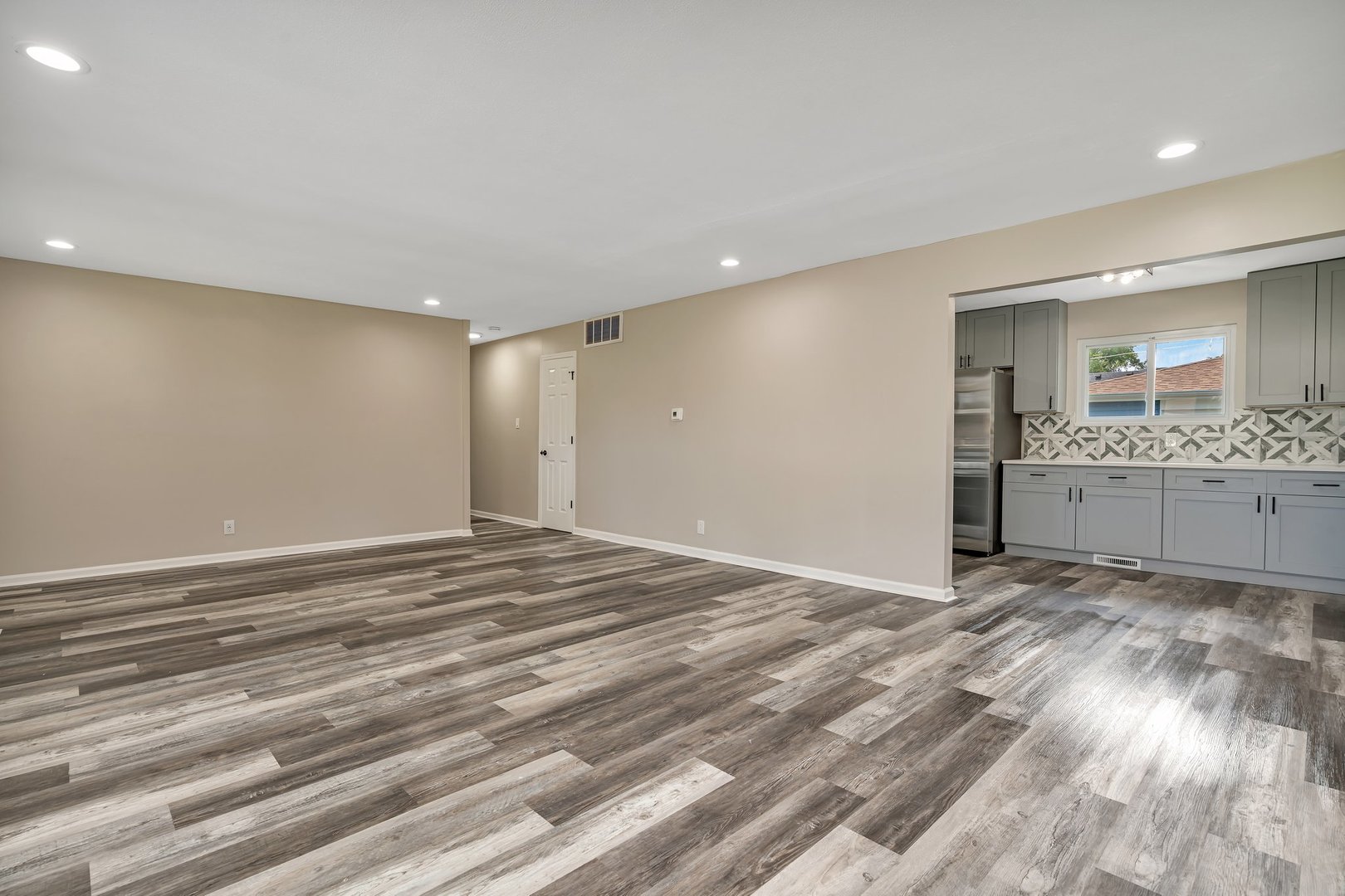 144 Queenswood Road Bolingbrook, IL 60440 - Photo 4 of 15 an empty room with wooden floor and a window