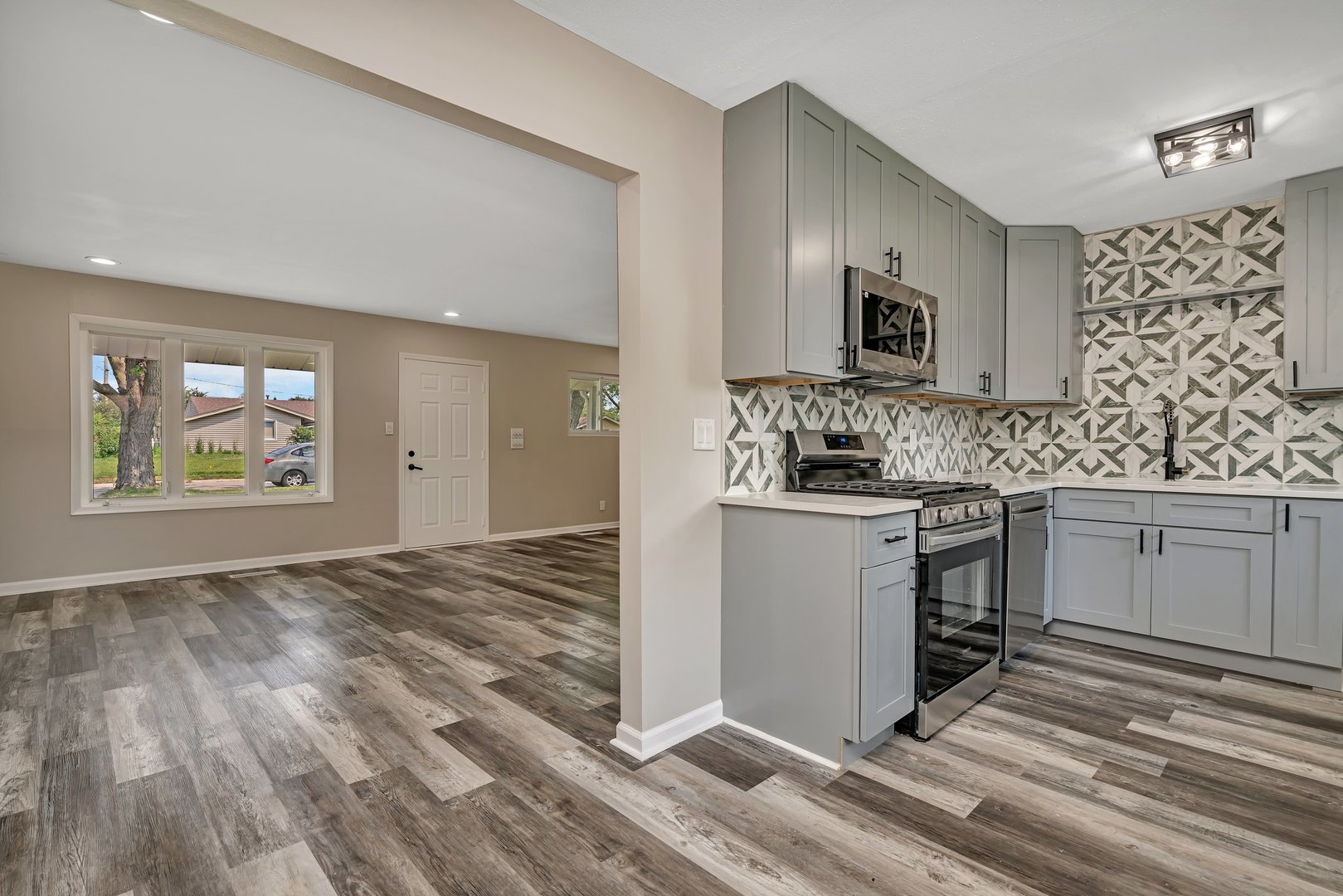 144 Queenswood Road Bolingbrook, IL 60440 - Photo 6 of 15 a kitchen with stainless steel appliances granite countertop a stove and a sink