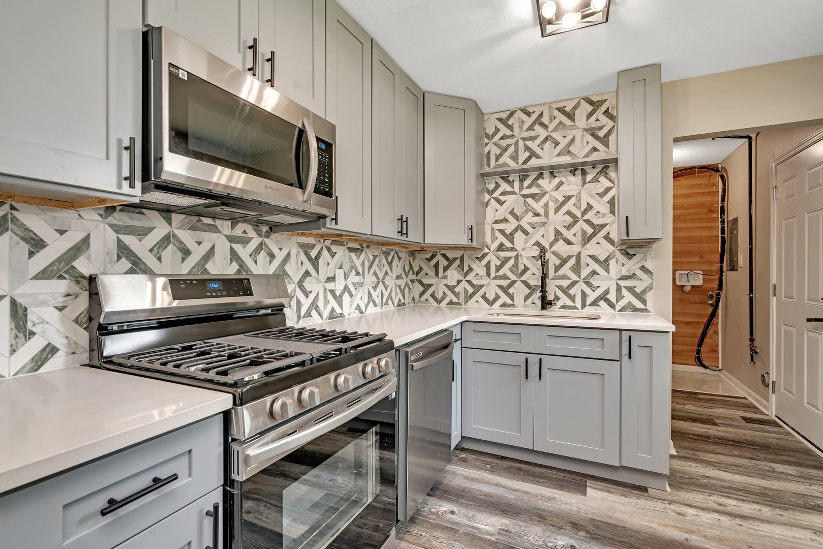 144 Queenswood Road Bolingbrook, IL 60440 - Photo 7 of 15 a kitchen with granite countertop a stove and a sink