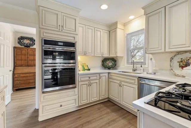 a kitchen with granite countertop cabinets stainless steel appliances and wooden floor