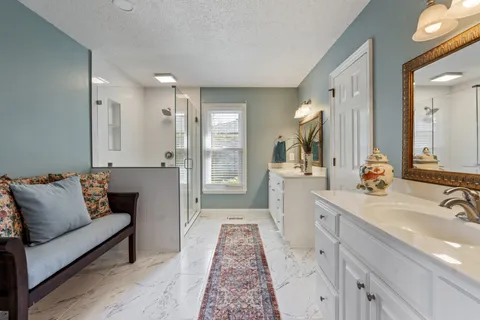 a spacious bathroom with a double vanity sink and a mirror