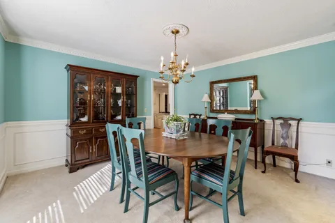 a dining room with furniture and window