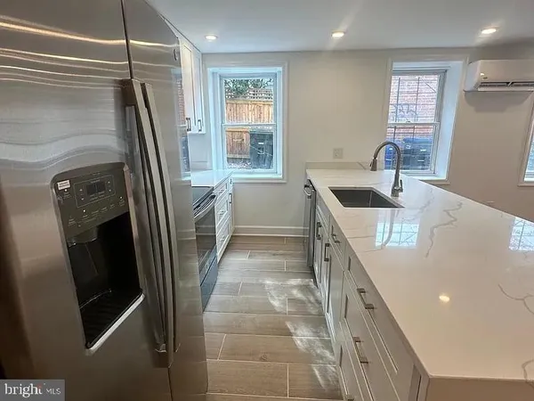 a kitchen with refrigerator and window
