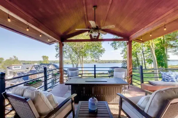a view of a patio with a table chairs and a backyard