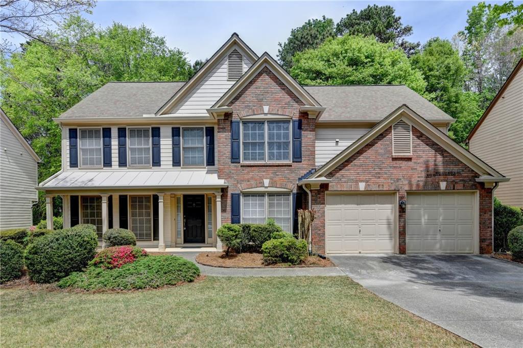 a front view of a house with a yard and porch