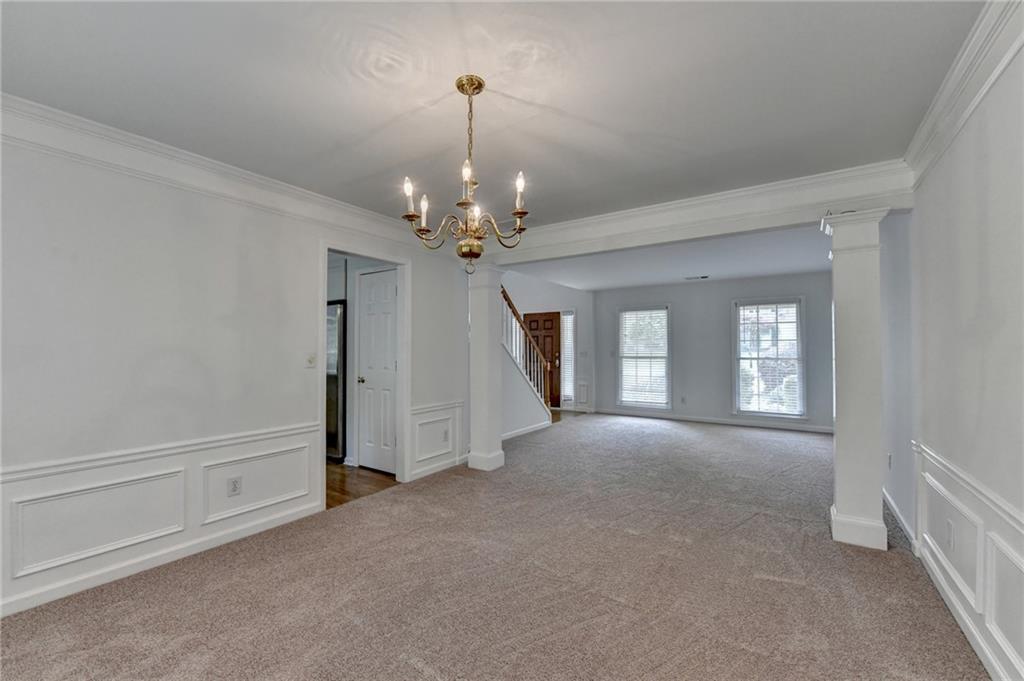 6535 Ganton Drive Duluth, GA 30097 - Photo 16 of 75 a view of a livingroom with a chandelier fan and windows