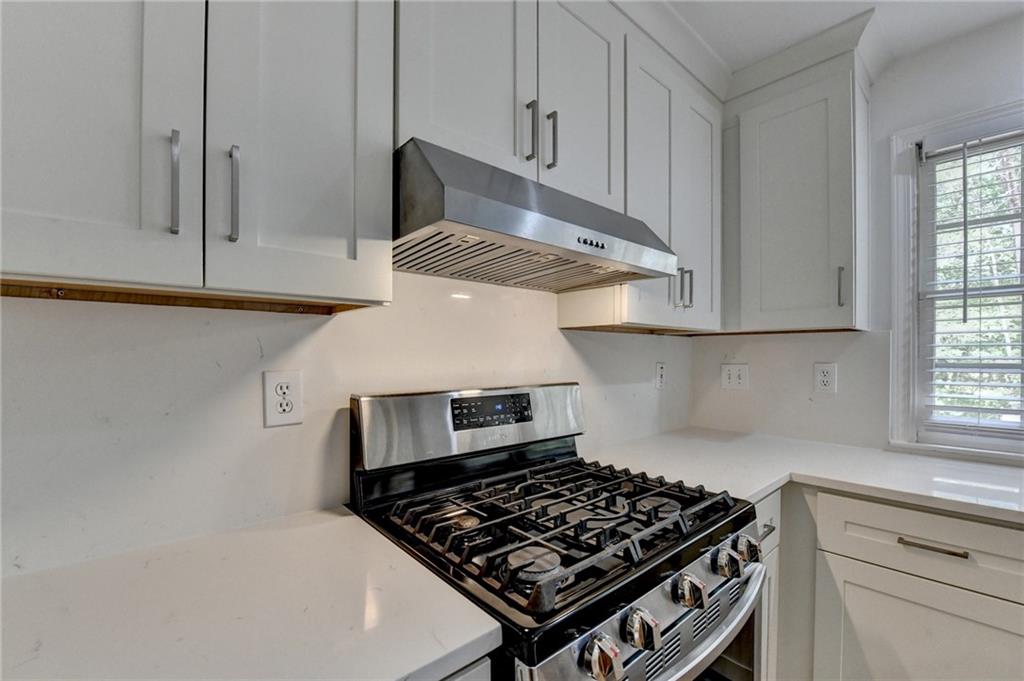 6535 Ganton Drive Duluth, GA 30097 - Photo 19 of 75 a kitchen with white cabinets and appliances