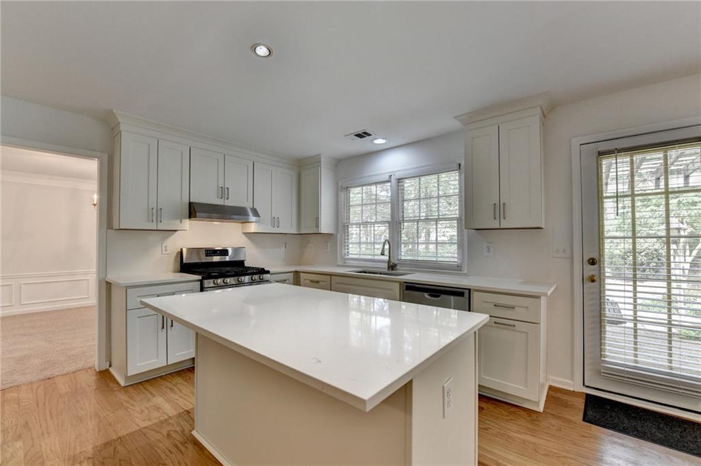 6535 Ganton Drive Duluth, GA 30097 - Photo 25 of 75 a kitchen with a stove a sink and a refrigerator