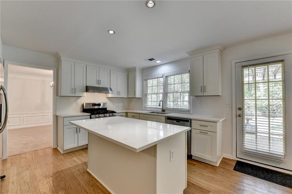 6535 Ganton Drive Duluth, GA 30097 - Photo 28 of 75 a kitchen with stainless steel appliances a stove a sink and a refrigerator